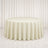 Elegant round table with ivory patterned tablecloth in a bright white room
