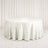 Elegant round white table with satin tablecloth in a minimalist setting