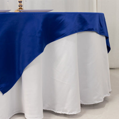 Blue satin tablecloth draped over a white table