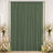 Elegant sage green pleated curtain backdrop with white floral arrangements and candles