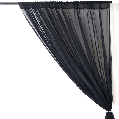 Sheer black curtain draped elegantly on a rod