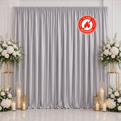 Elegant silver wedding backdrop curtain with floral arrangements and candles