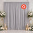 Elegant silver wedding backdrop curtain with floral arrangements and candles