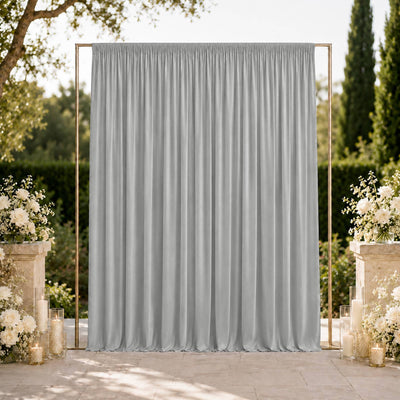 Elegant silver wedding backdrop with floral arrangements and candles outdoors