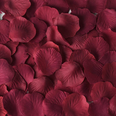 Red silk rose petals arranged in a textured pattern. #whtbkgd