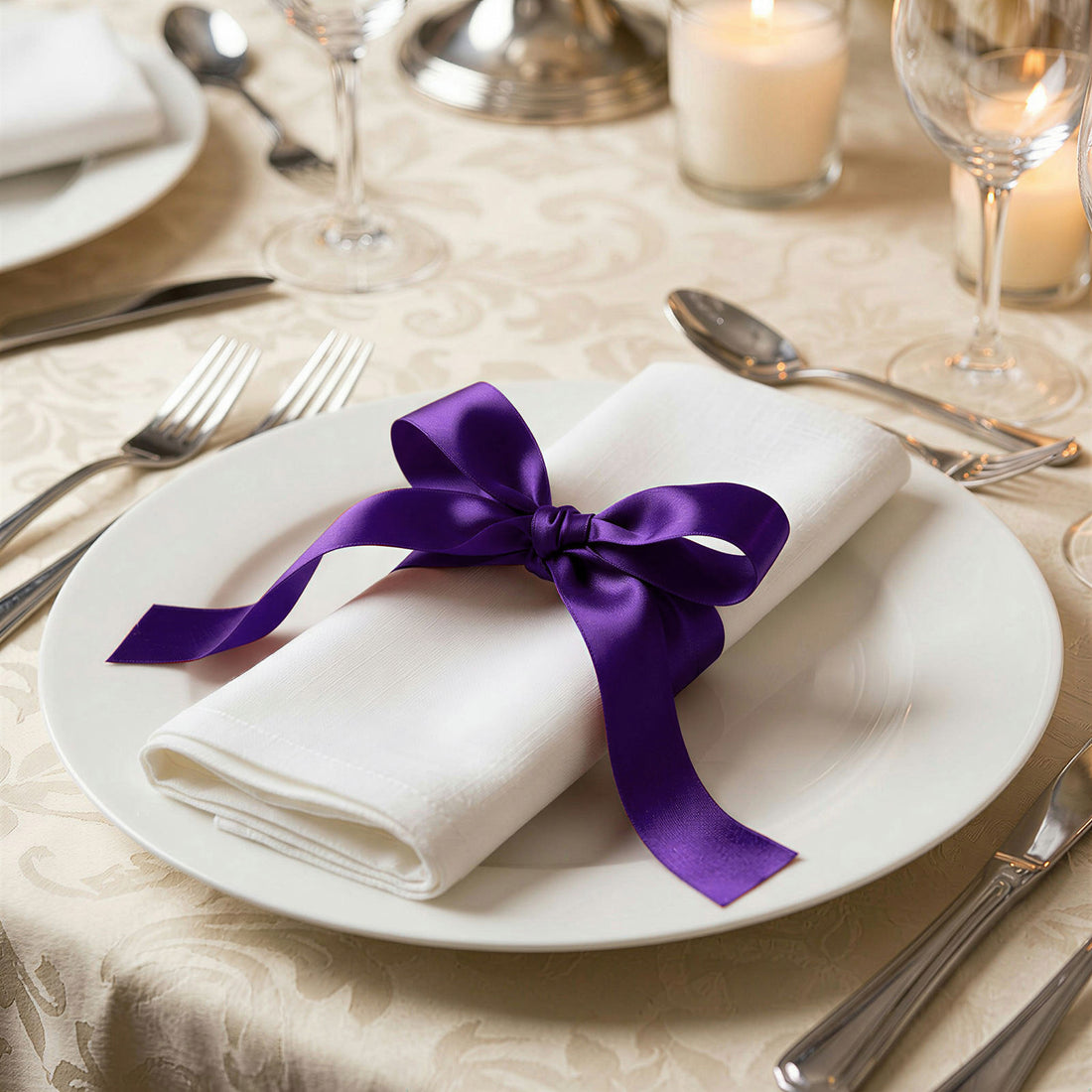 Elegant table setting with white napkin and purple ribbon bow on plate