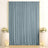 Elegant wedding backdrop with blue drapes, floral arrangements, and candles