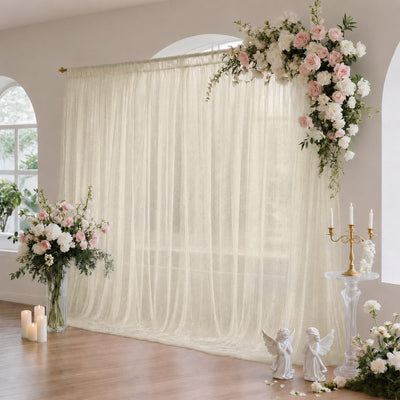 Elegant wedding floral arch with ivory drapes and pastel rose decor