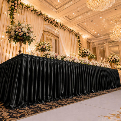 Elegant wedding reception stage with floral arrangements and chandeliers