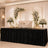Elegant wedding reception stage with floral backdrop, white loveseat, and lanterns