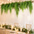Elegant wedding reception table with greenery, candles, and hanging ferns