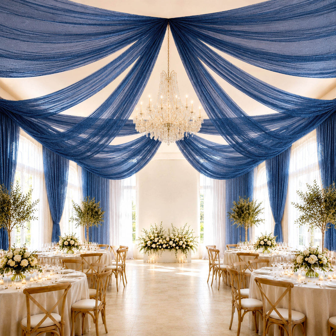 Elegant wedding reception with blue draped ceiling and chandelier