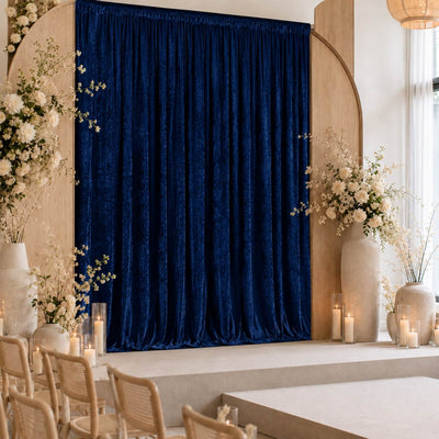 Elegant wedding stage with navy velvet curtain and white floral arrangements