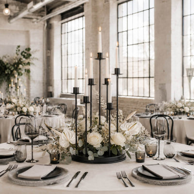 Elegant wedding table centerpiece with candles and white floral arrangement