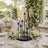 Elegant wedding table centerpiece with candles, white flowers, and gold tableware