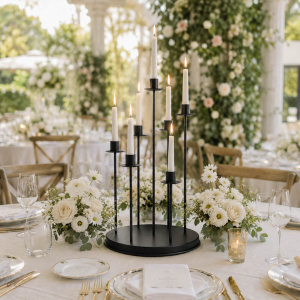 Elegant wedding table centerpiece with candles, white flowers, and gold tableware