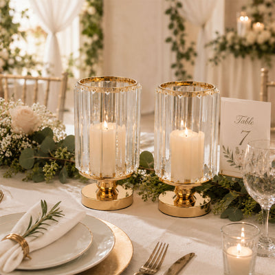 Elegant wedding table centerpiece with gold candle holders and greenery