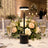 Elegant wedding table centerpiece with LED lamp, roses, champagne glasses, and candles