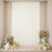 Elegant white curtain backdrop with floral arrangements, balloons, and candles