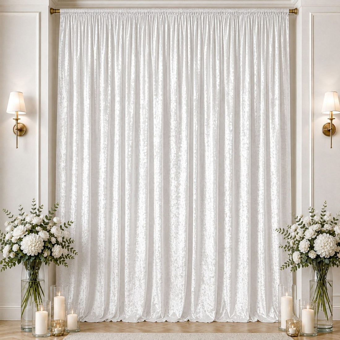 Elegant white draped curtain backdrop with floral arrangements and candles