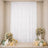 Elegant white floral backdrop with pastel balloons and candles for a party event