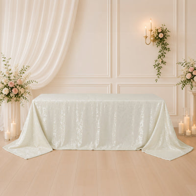 Elegant white lace tablecloth in a floral wedding reception setup