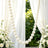Elegant white pearl garland wedding backdrop with draped curtains and white roses
