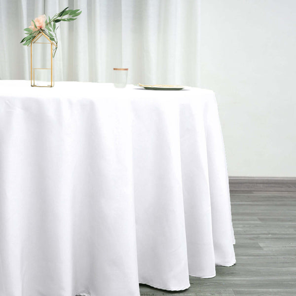 White tablecloth draping elegantly over a table with minimal decor.