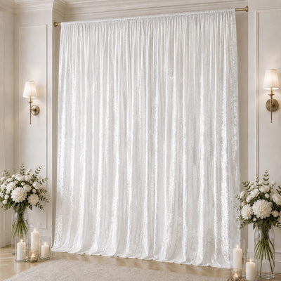 Elegant white velvet curtain with gold wall sconces and floral decor
