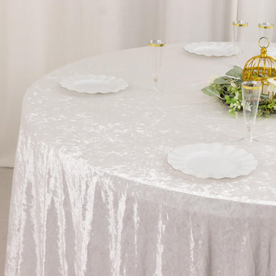 Elegant white velvet tablecloth with gold-rimmed champagne glasses and decor