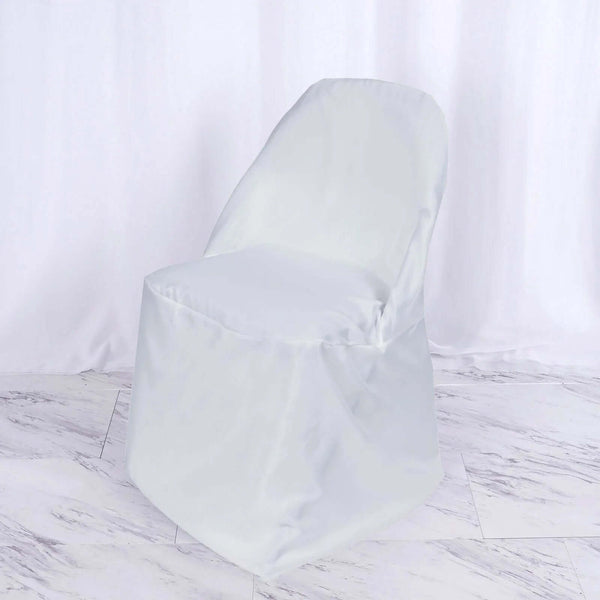 White chair with a soft cover on a plain backdrop