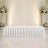 Elegant white wedding stage with floral arrangements and draped backdrop