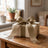 Elegant wrapped gift box with gold ribbon on wooden table