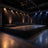 Empty black stage with truss lighting, podiums, and draped platform