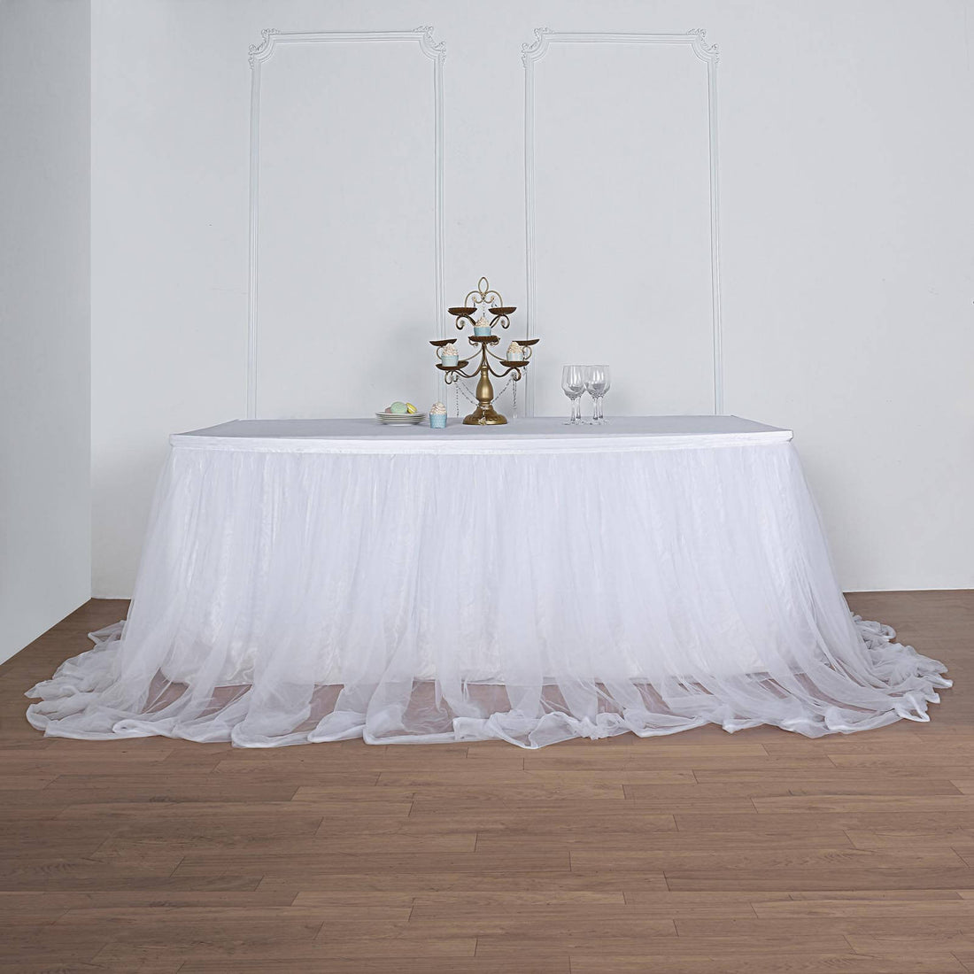 Elegant white table skirt draping over a table in a staged setting.