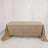 Beige tablecloth draped over a table in a studio setting.
