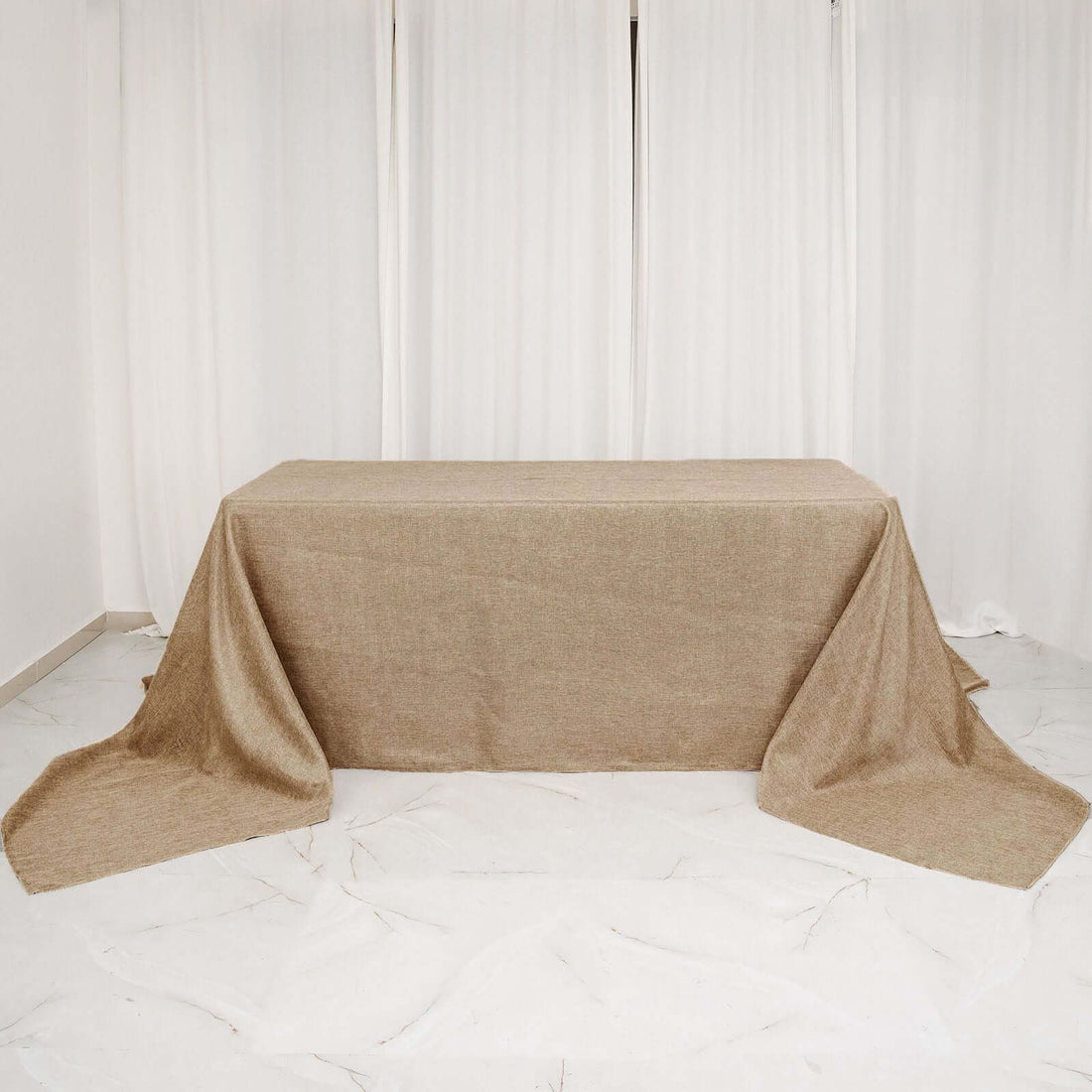 Natural burlap tablecloth on a table with draped edges