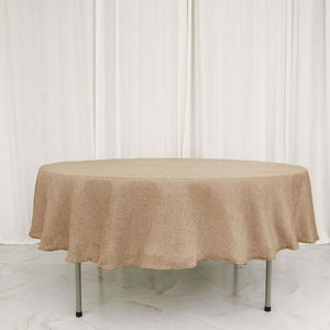 Round beige tablecloth on a table with a plain background.