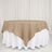 Round burlap tablecloth draped over a white table skirt.