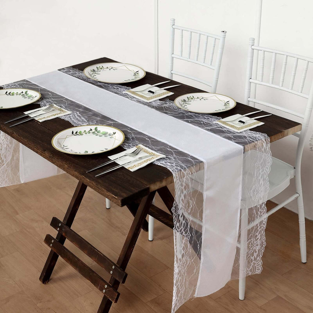 Elegant dining setup with lace table runner and decorative plates.