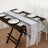 Elegant dining setup with lace table runner and decorative plates.