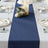 Elegant navy table runner on a beautifully set dining table with floral accents.