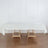 White linen tablecloth draped over two wooden tables.