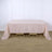 Light pink tablecloth draped over a wooden table