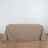 Beige tablecloth draped over a table against a plain background.
