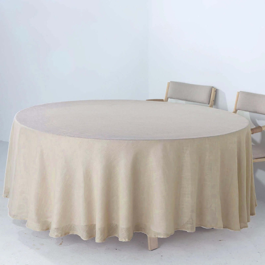Round beige tablecloth draped elegantly over a table