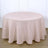 Round beige tablecloth with textured pattern on a white backdrop.