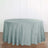 Round light blue tablecloth on a wooden surface.