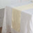 Yellow table runner on a white tablecloth in a bright setting.