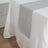 Sheer white tablecloth with gray runner on dining table